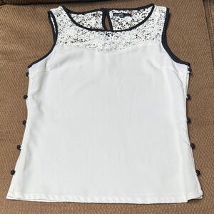 C. Luce cream & black sleeveless top w/ embroidered top & black side buttons. M